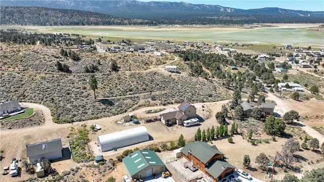 birds eye view of property featuring a water and mountain view