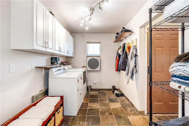 laundry area with washing machine and clothes dryer and cabinets