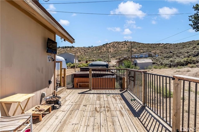 wooden terrace featuring a hot tub