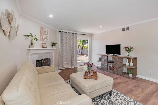 living room with ornamental molding and hardwood / wood-style flooring