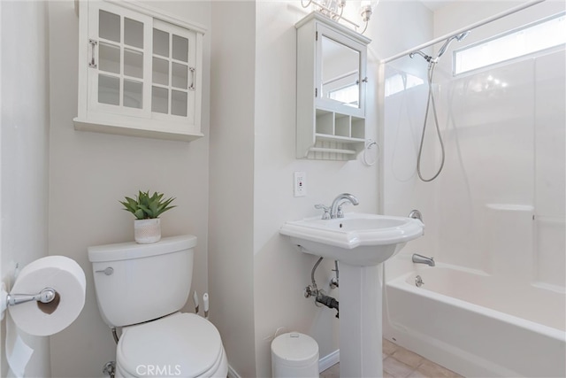 bathroom with bathing tub / shower combination and toilet