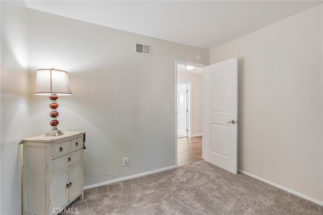 unfurnished bedroom featuring light carpet