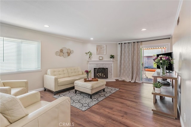 living room with ornamental molding and hardwood / wood-style floors