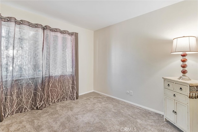 unfurnished room featuring light carpet