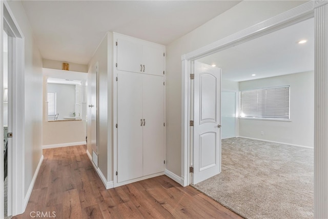 hallway with light hardwood / wood-style flooring