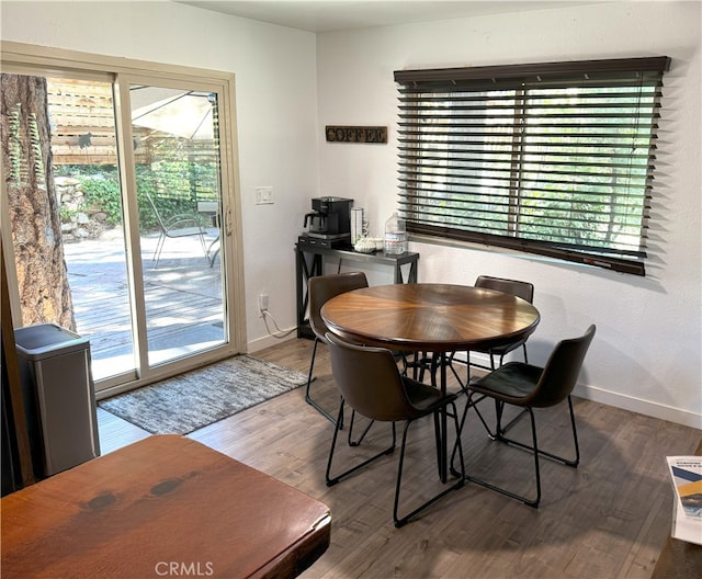 dining space with hardwood / wood-style floors