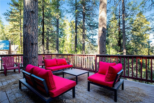 wooden terrace with an outdoor living space