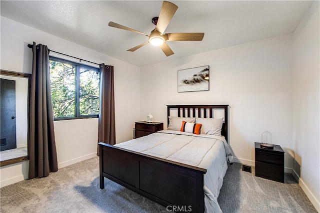 bedroom featuring light carpet and ceiling fan