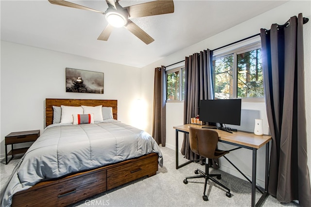 bedroom with light carpet and ceiling fan