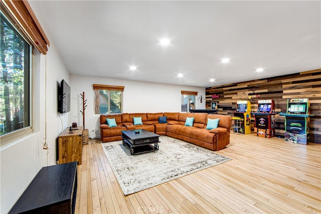 living room featuring light hardwood / wood-style floors and wood walls