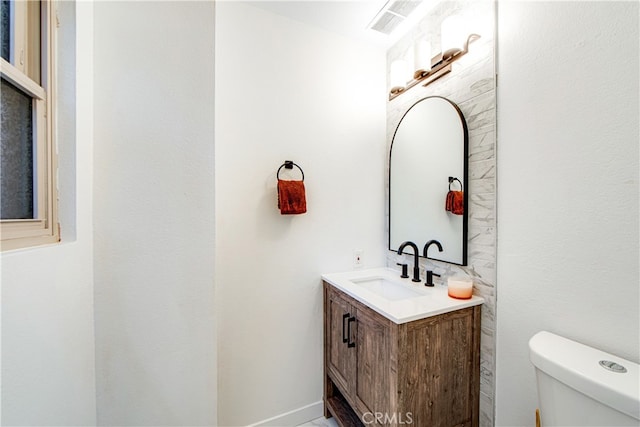 bathroom featuring toilet and vanity