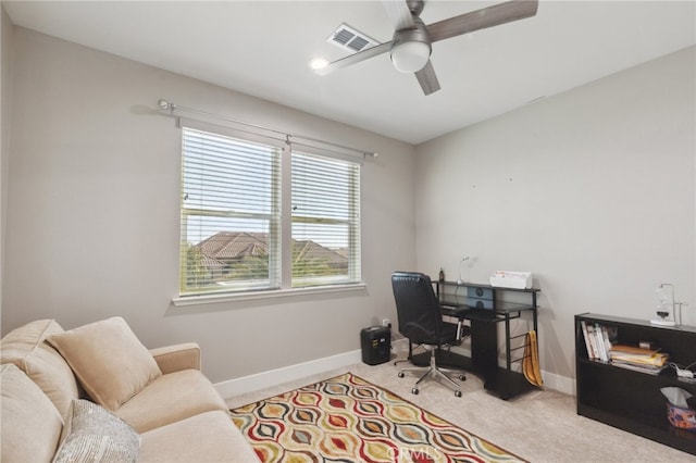 carpeted office space with ceiling fan