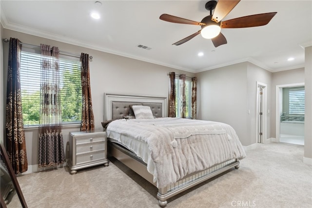 carpeted bedroom with crown molding, ceiling fan, and ensuite bathroom