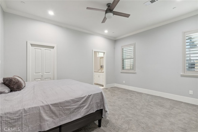 carpeted bedroom featuring ceiling fan, ensuite bathroom, a closet, and ornamental molding