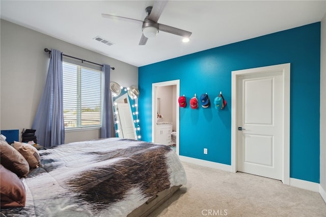 bedroom with ensuite bath, ceiling fan, and light colored carpet