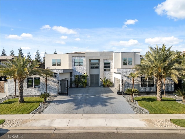 contemporary home with a front lawn