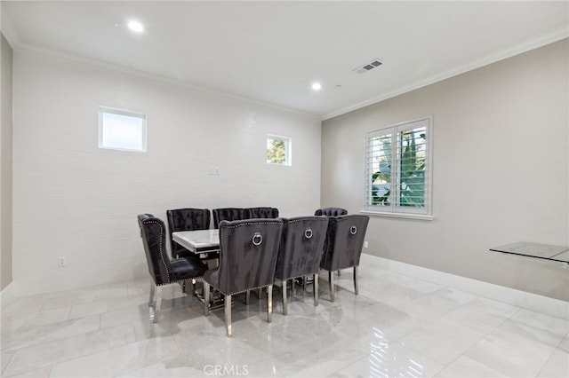 dining area featuring crown molding