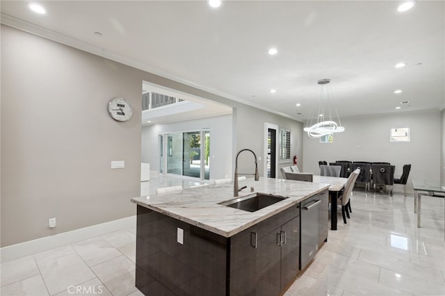 kitchen with a large island with sink, dishwasher, dark brown cabinets, ornamental molding, and sink