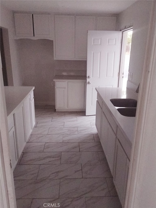 kitchen with white cabinets and sink