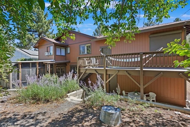 back of house featuring a deck and a sunroom