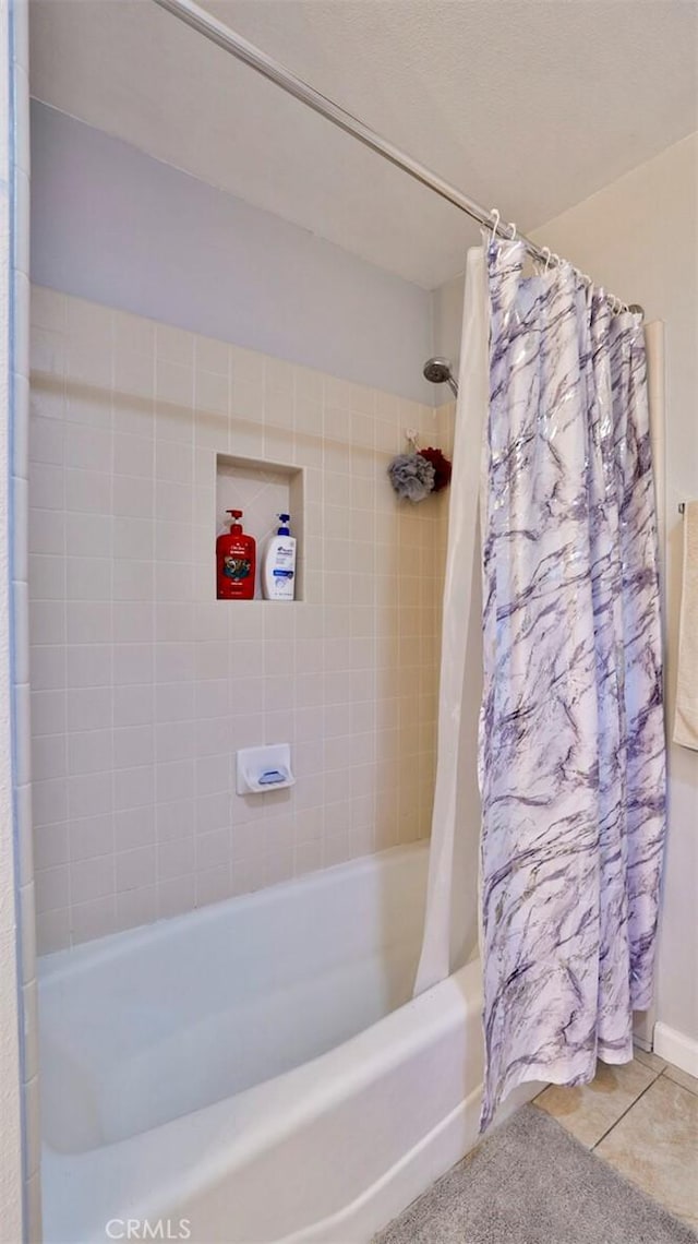 bathroom featuring tile patterned flooring and shower / bathtub combination with curtain