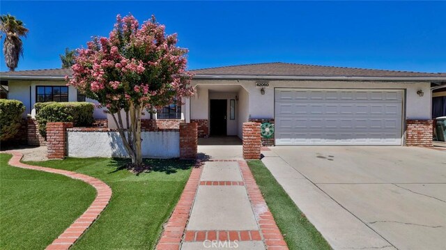 view of front facade with a front lawn and a garage