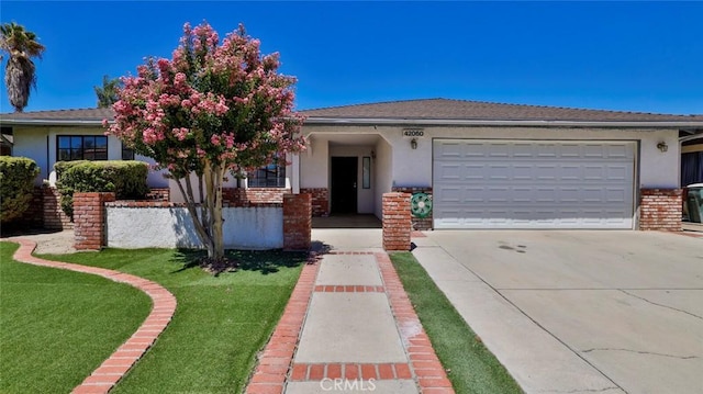 view of front of house with a garage and a front lawn