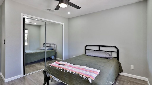 bedroom featuring hardwood / wood-style flooring, a closet, and ceiling fan