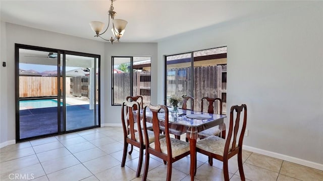 tiled dining area with a chandelier