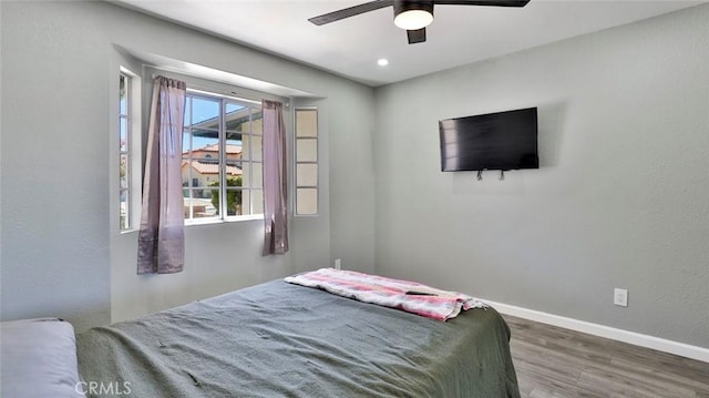 bedroom featuring dark hardwood / wood-style flooring and ceiling fan