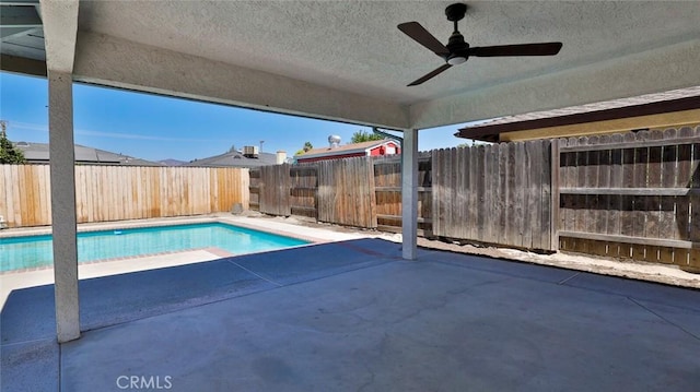 view of swimming pool with ceiling fan and a patio area