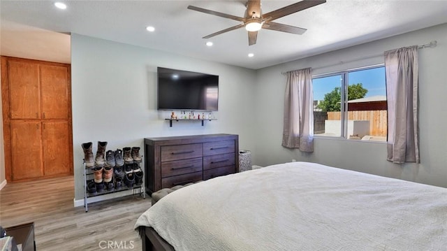 bedroom with ceiling fan and light hardwood / wood-style floors