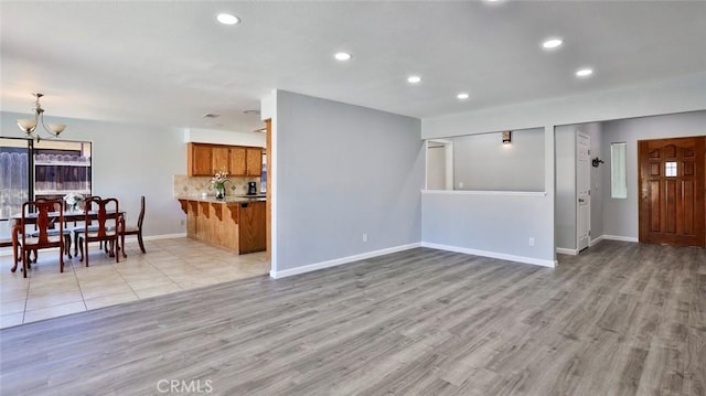 living room featuring a chandelier and light hardwood / wood-style flooring