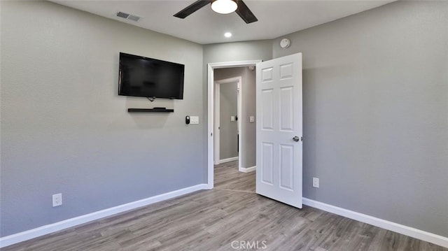 unfurnished bedroom featuring light wood-type flooring and ceiling fan