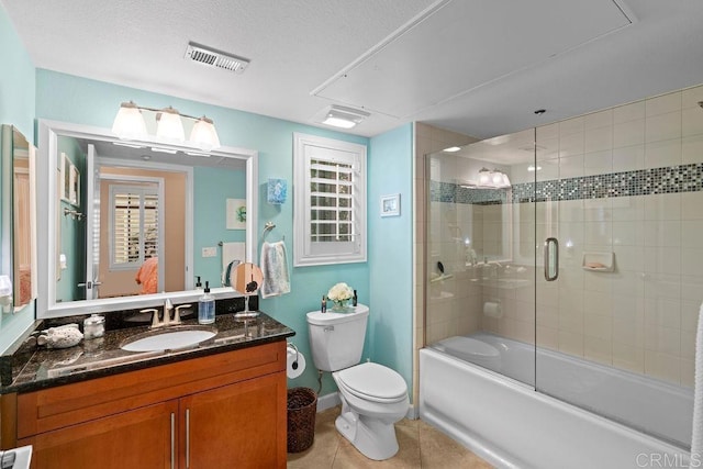 bathroom with tile patterned flooring, visible vents, toilet, shower / bath combination with glass door, and vanity