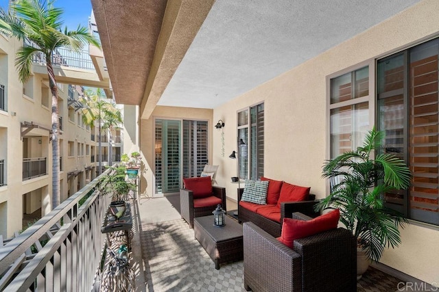 view of patio featuring an outdoor hangout area and a balcony