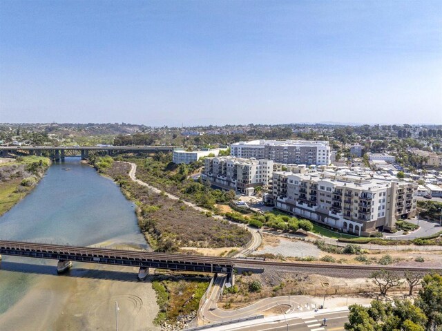 birds eye view of property with a view of city and a water view