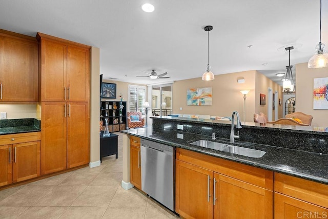 kitchen featuring dishwasher, brown cabinetry, and a sink