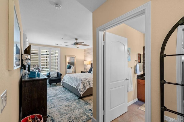 bedroom featuring light tile patterned flooring and a ceiling fan