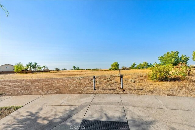 view of yard with a rural view