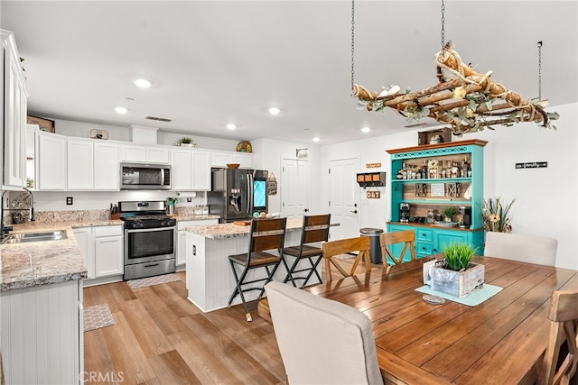 dining room featuring light hardwood / wood-style floors and sink