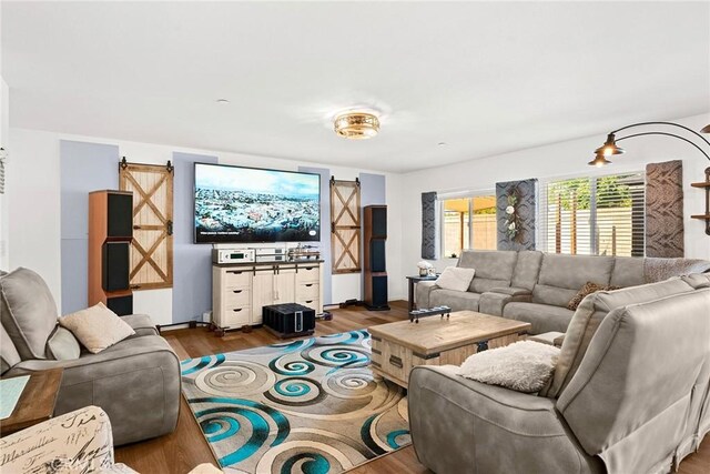 living room with hardwood / wood-style floors and a barn door