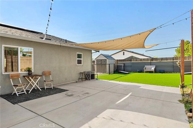 view of patio with a storage unit