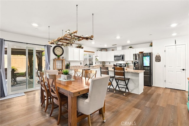 dining space with light hardwood / wood-style floors