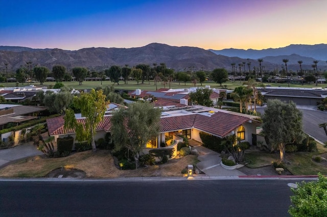 aerial view at dusk featuring a mountain view