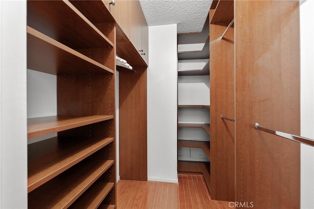 spacious closet featuring light hardwood / wood-style floors