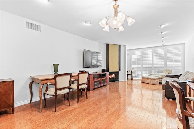 living room featuring an inviting chandelier and light wood-type flooring