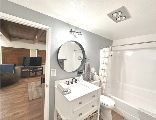 full bathroom with vanity, toilet, a textured ceiling, shower / bathtub combination with curtain, and hardwood / wood-style floors