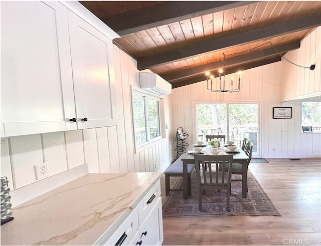 dining room with a chandelier, a wall unit AC, dark hardwood / wood-style floors, vaulted ceiling with beams, and wooden ceiling