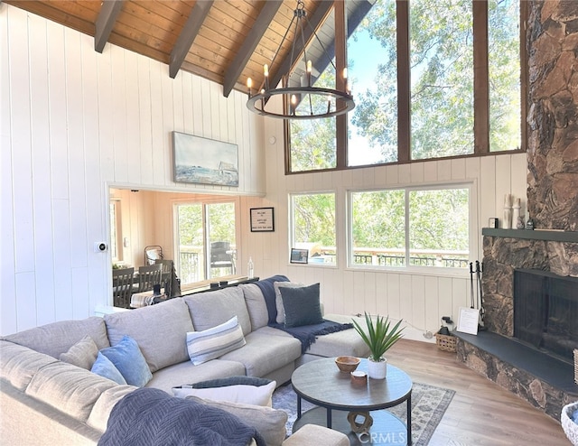 living room with a healthy amount of sunlight, wood walls, and hardwood / wood-style flooring